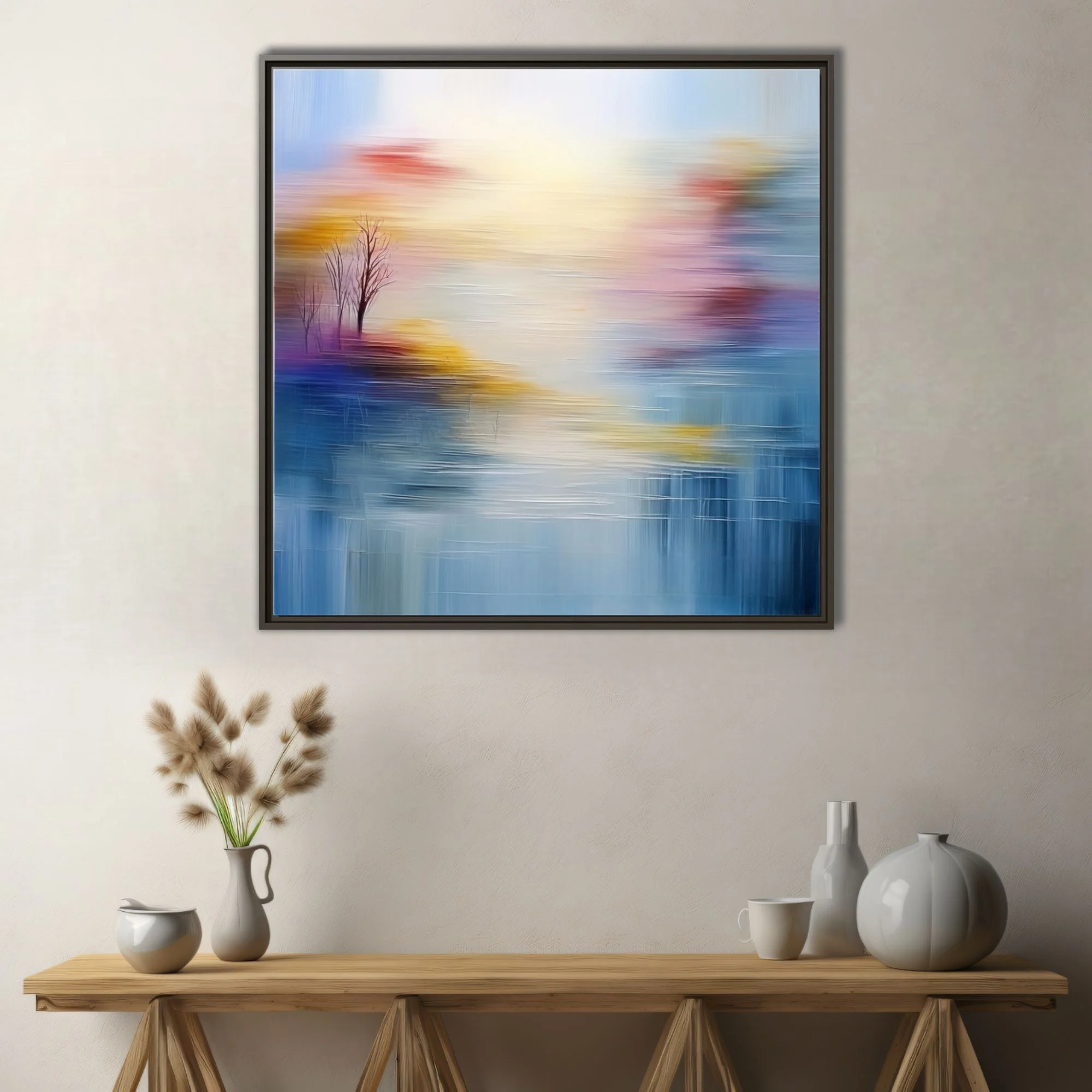 Soft-focus abstract landscape in hazy blue, gold and blush with bare tree silhouettes