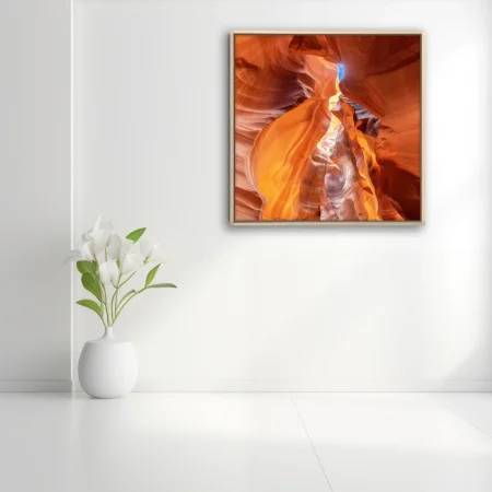 Canyon art, swirling amber sandstone with a blue sky opening