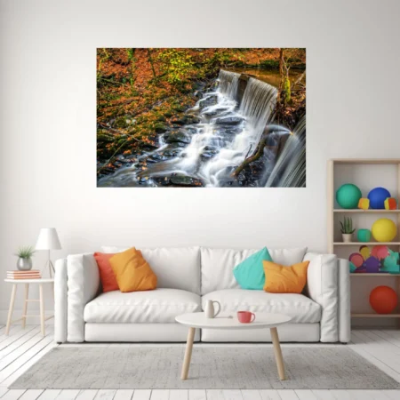 Long-exposure autumn forest waterfall over mossy rocks, warm amber and russet tones