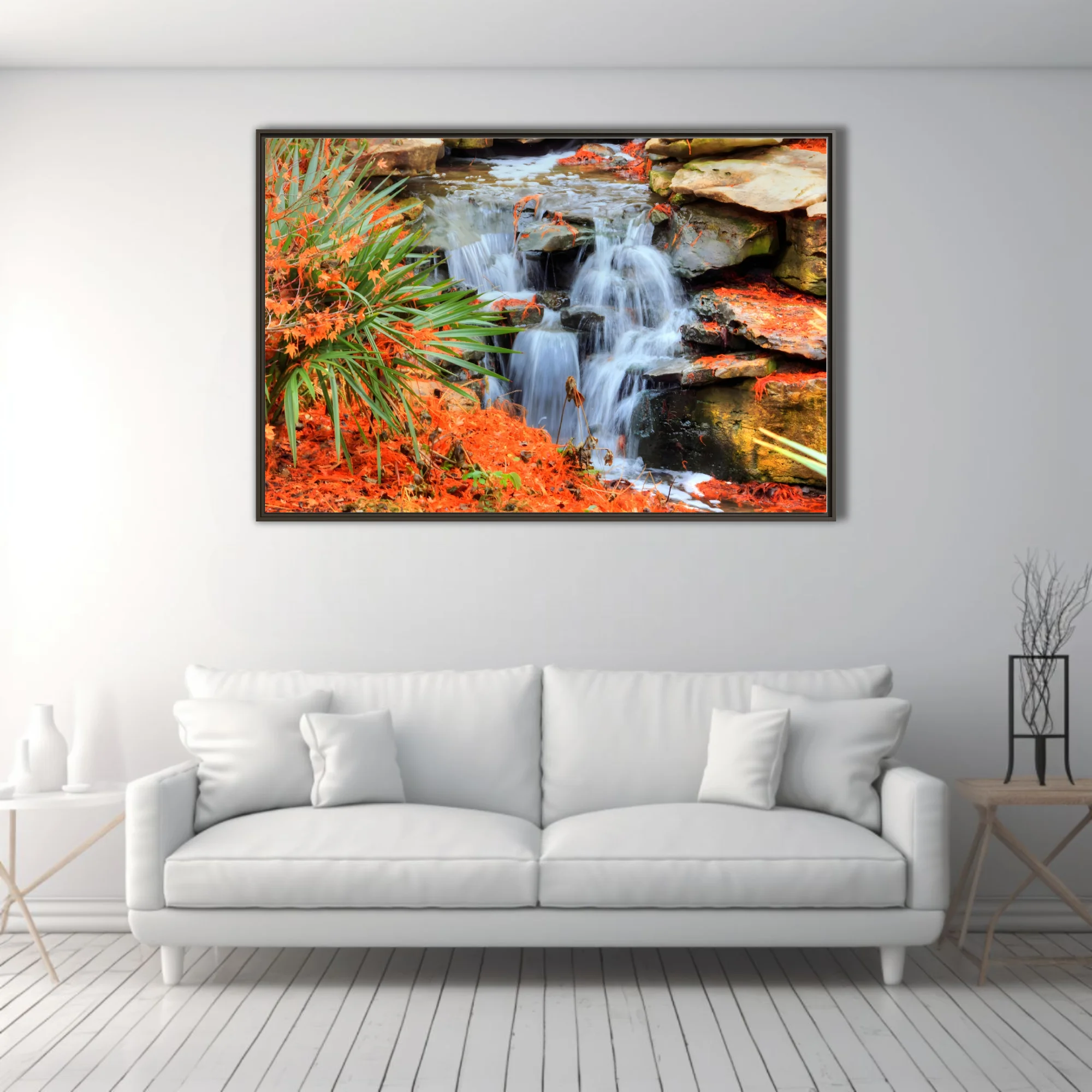 Cascading waterfall over mossy rocks with vivid orange foliage and green palms