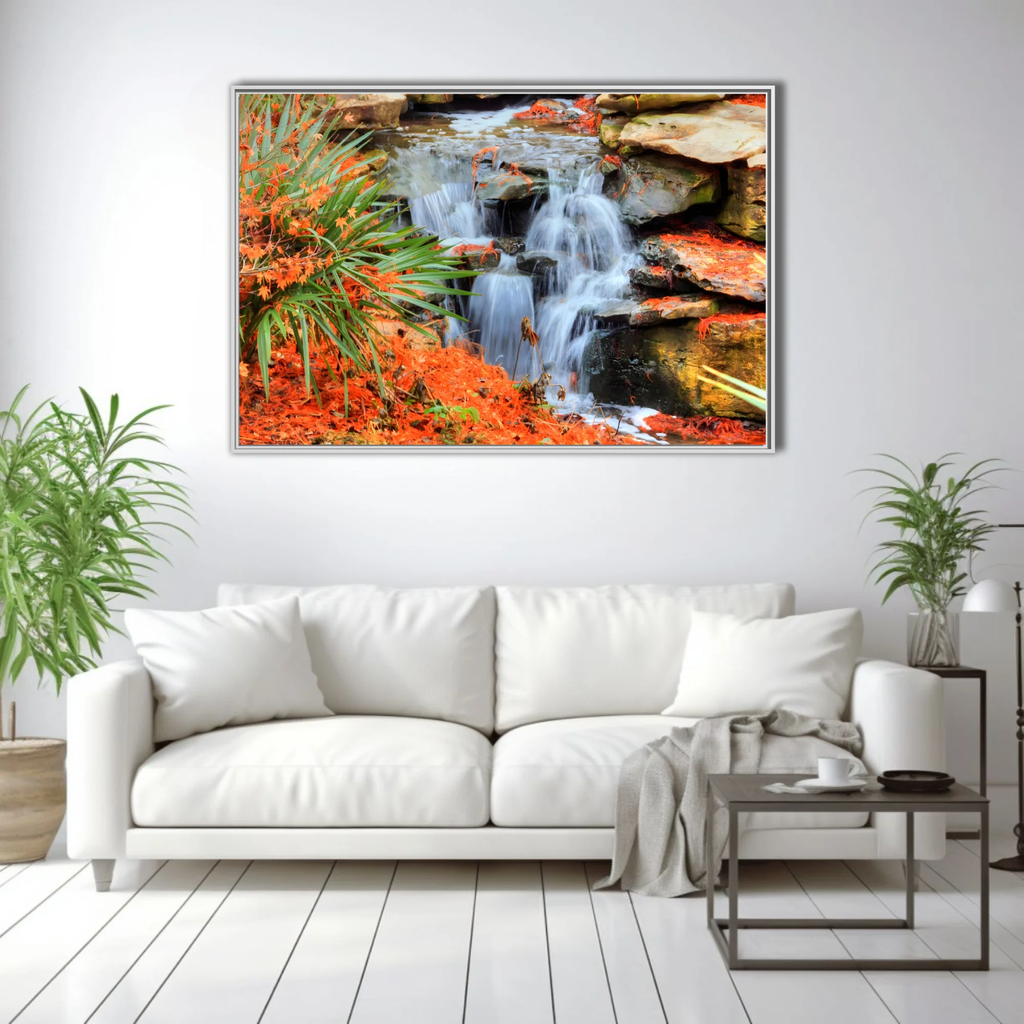 Cascading waterfall over mossy rocks with vivid orange foliage and green palms