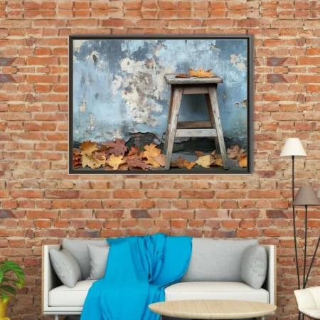 Rustic wooden stool with autumn leaves against peeling blue wall
