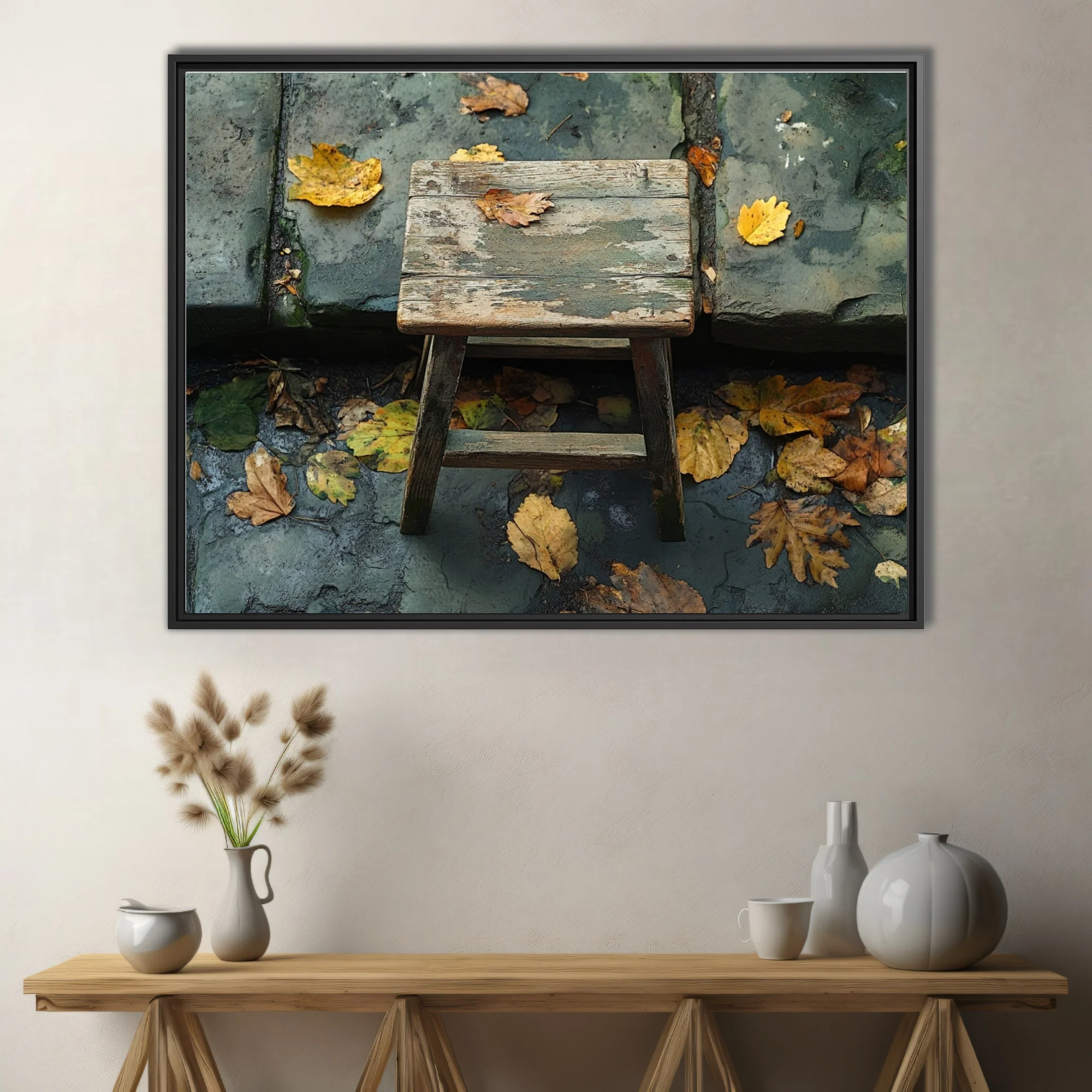Rustic weathered wooden stool with fallen autumn leaves on aged stone