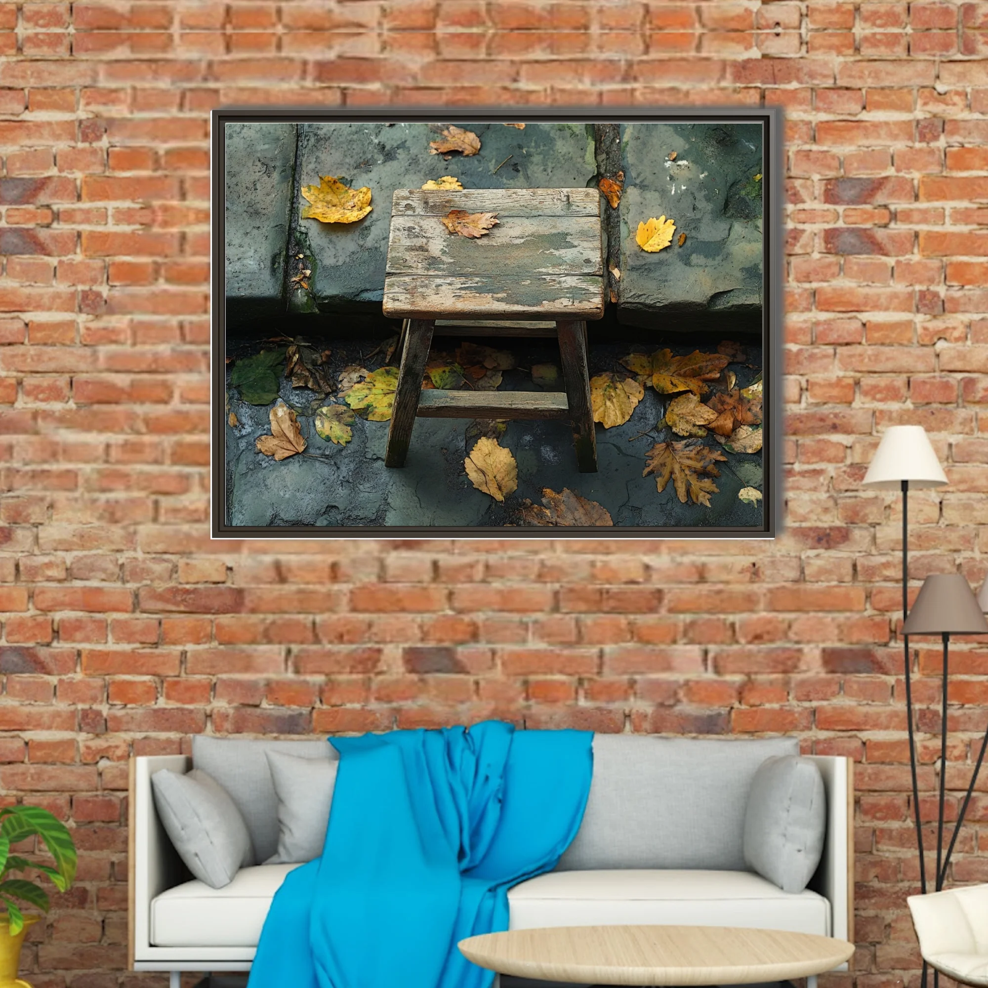 Rustic weathered wooden stool with fallen autumn leaves on aged stone