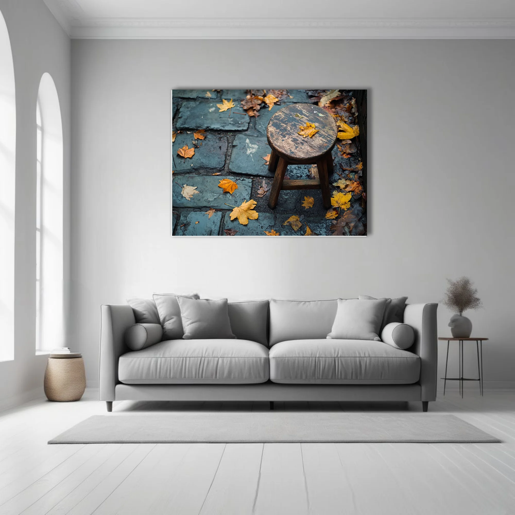 Rustic wooden stool on wet cobblestone with scattered autumn leaves, moody seasonal photo