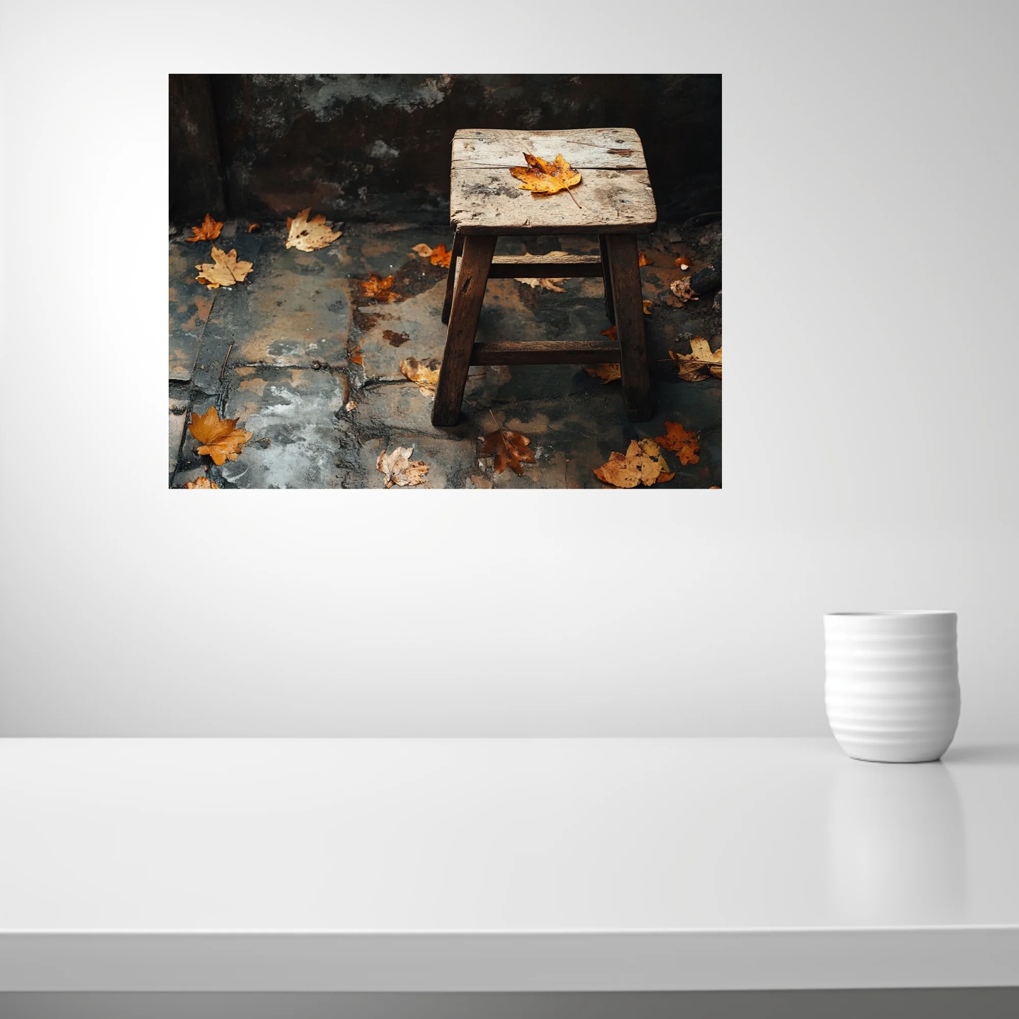 Rustic wooden stool with fallen autumn leaves on weathered stone — moody seasonal still life