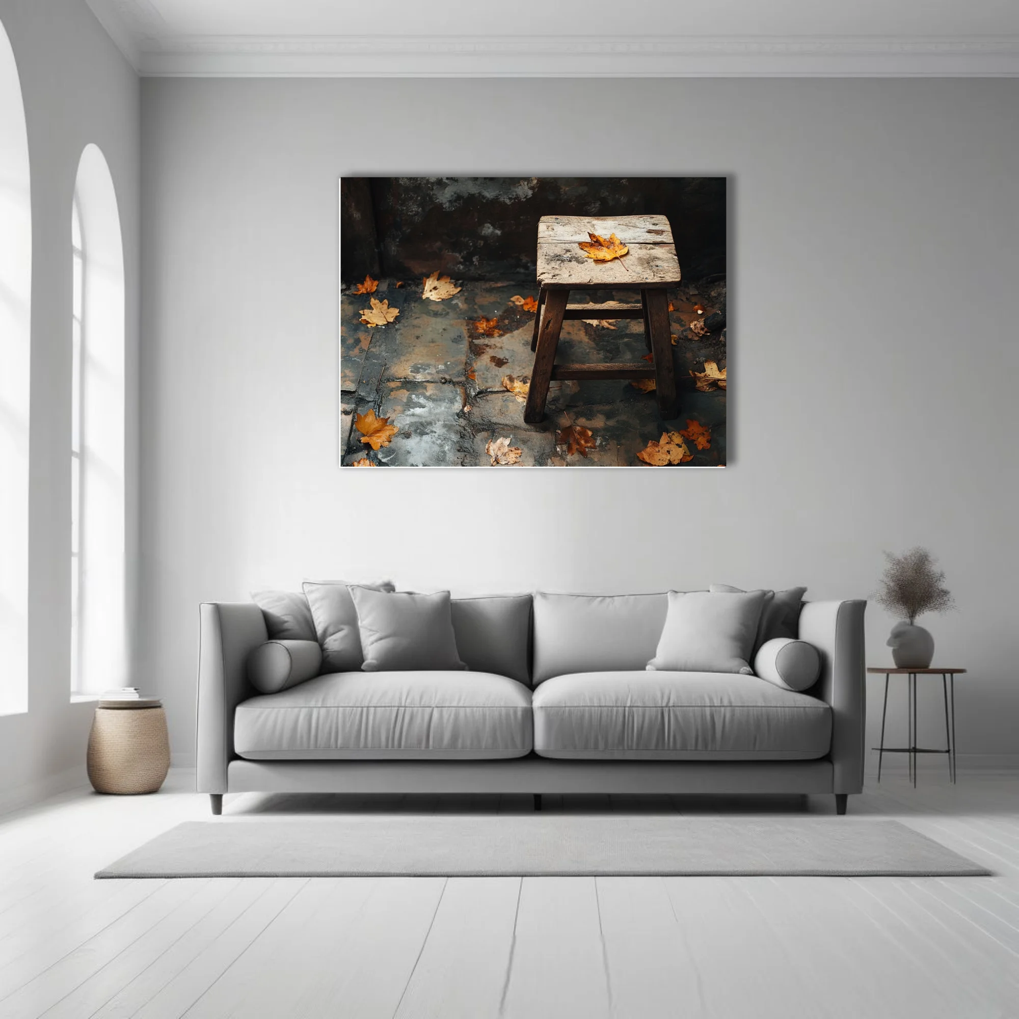 Rustic wooden stool with fallen autumn leaves on weathered stone — moody seasonal still life