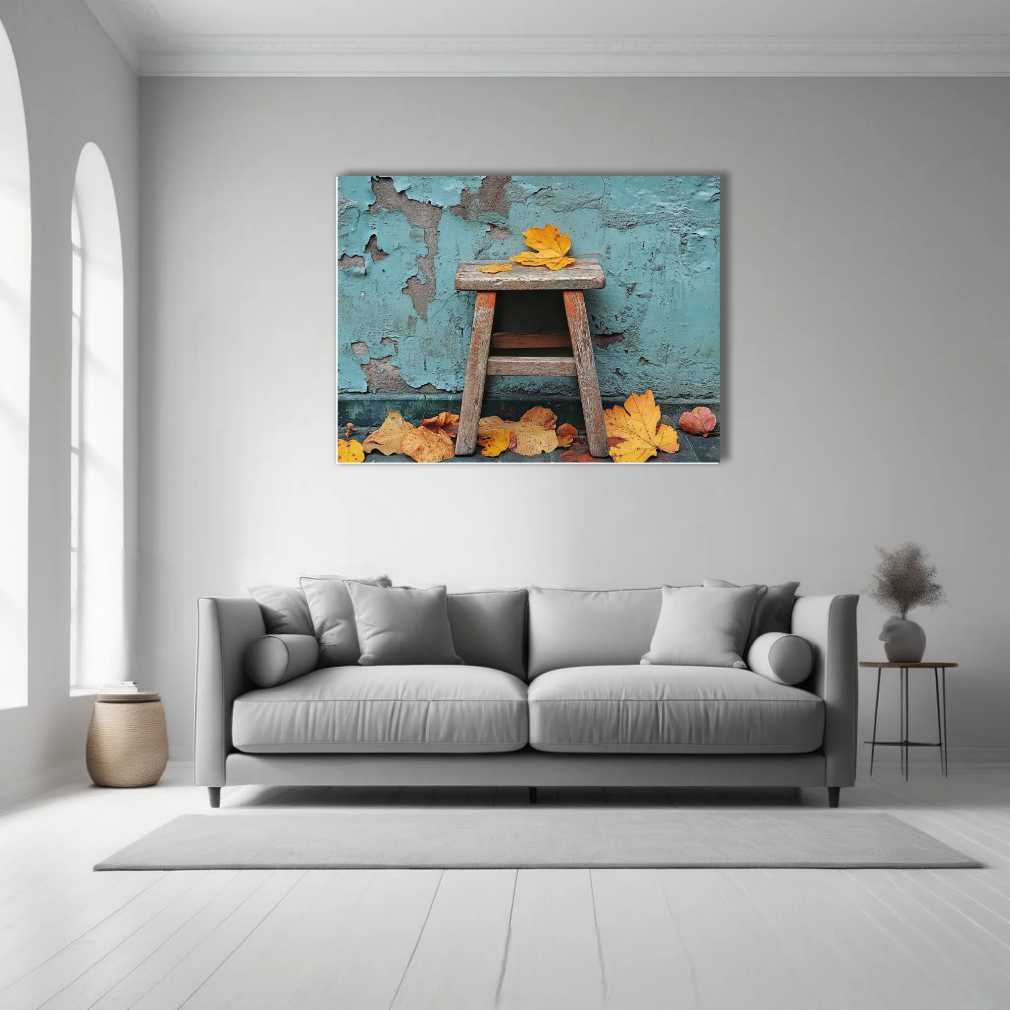 Rustic wooden stool with golden autumn leaves against peeling teal wall