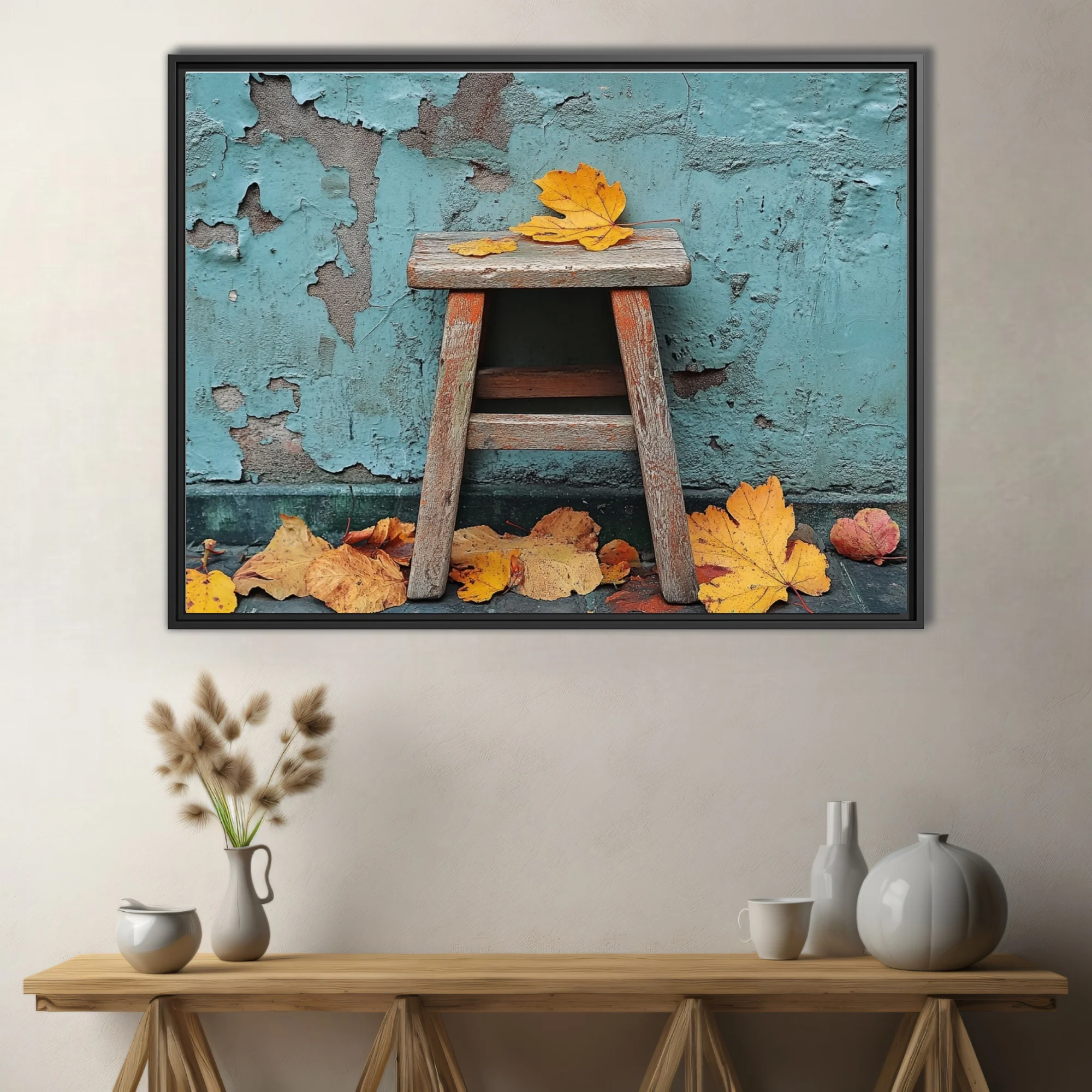 Rustic wooden stool with golden autumn leaves against peeling teal wall