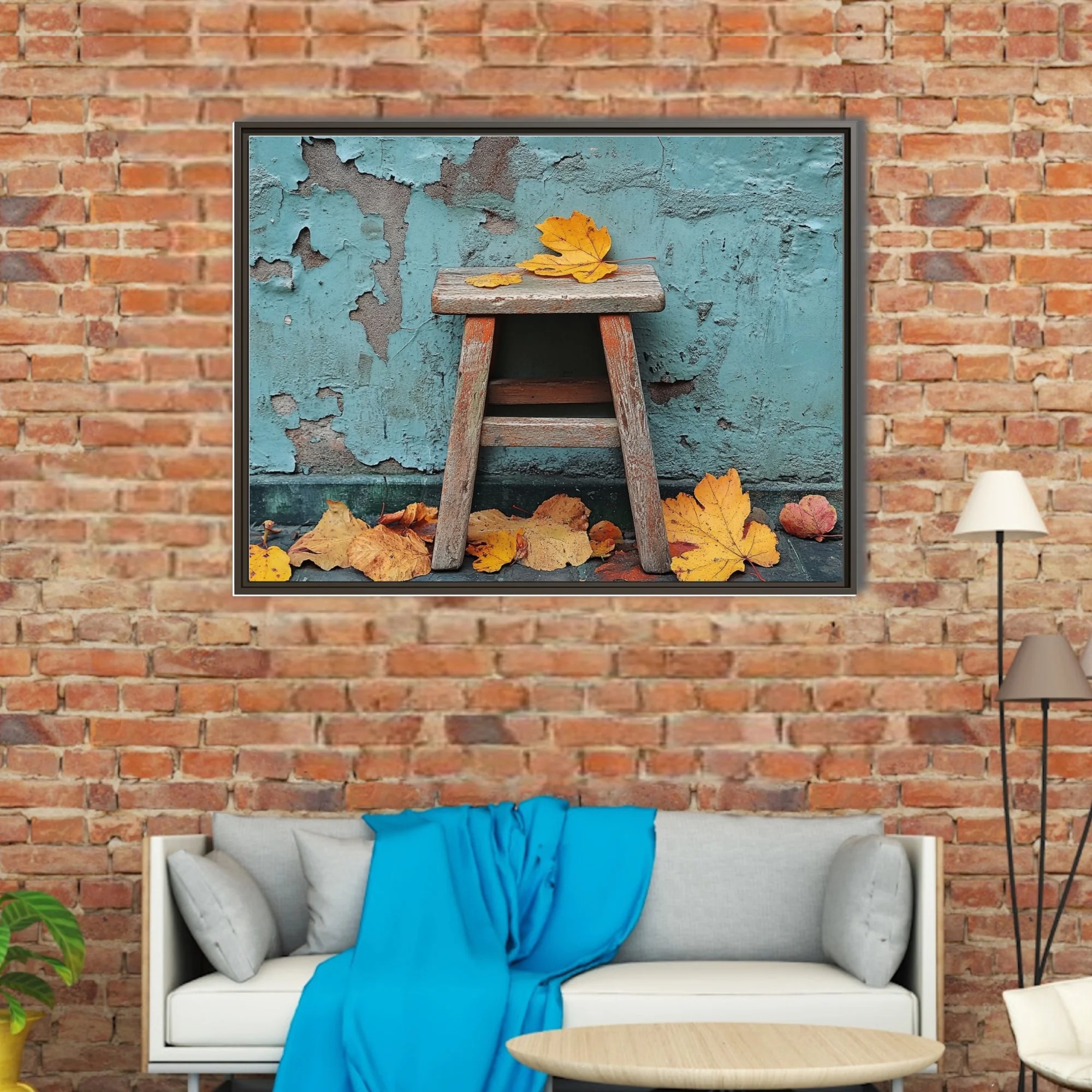 Rustic wooden stool with golden autumn leaves against peeling teal wall