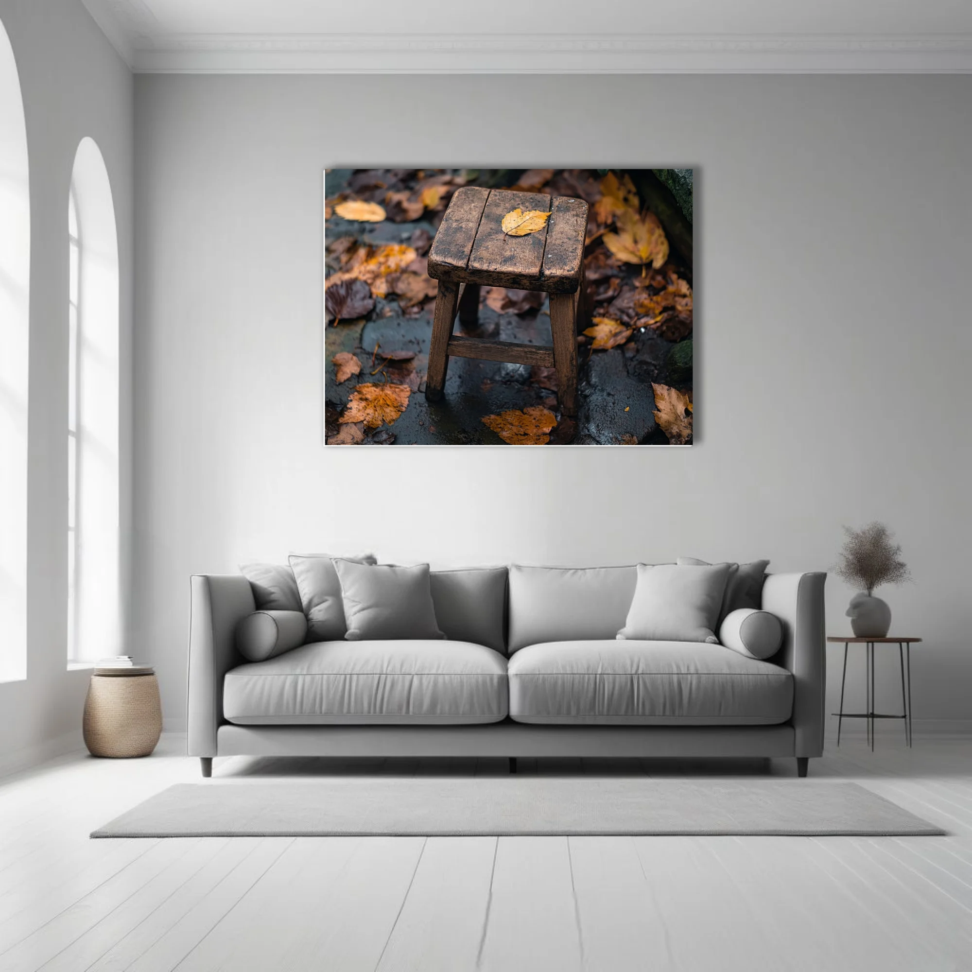 Rustic wooden stool with fallen autumn leaf on rain-wet stone surrounded by foliage