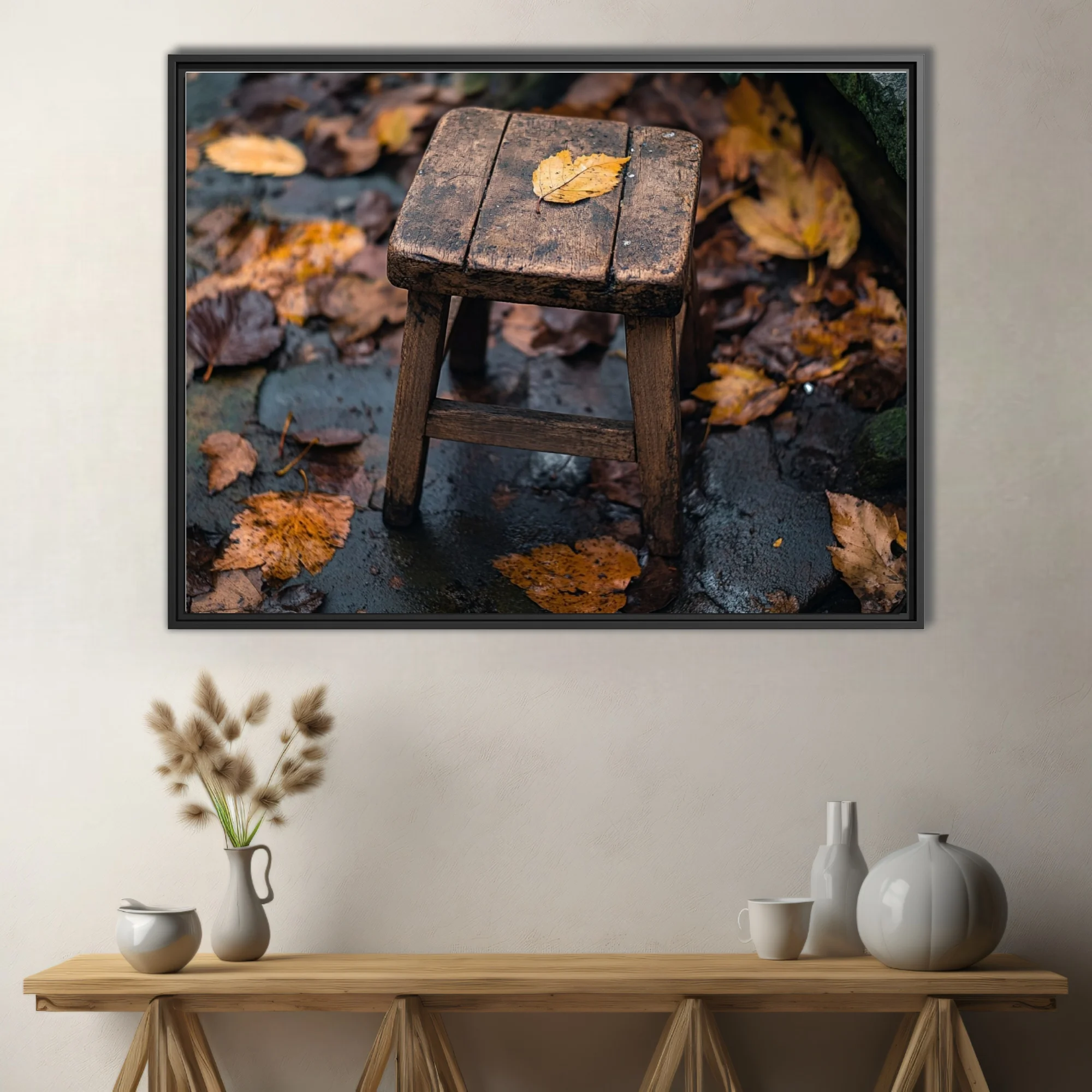 Rustic wooden stool with fallen autumn leaf on rain-wet stone surrounded by foliage