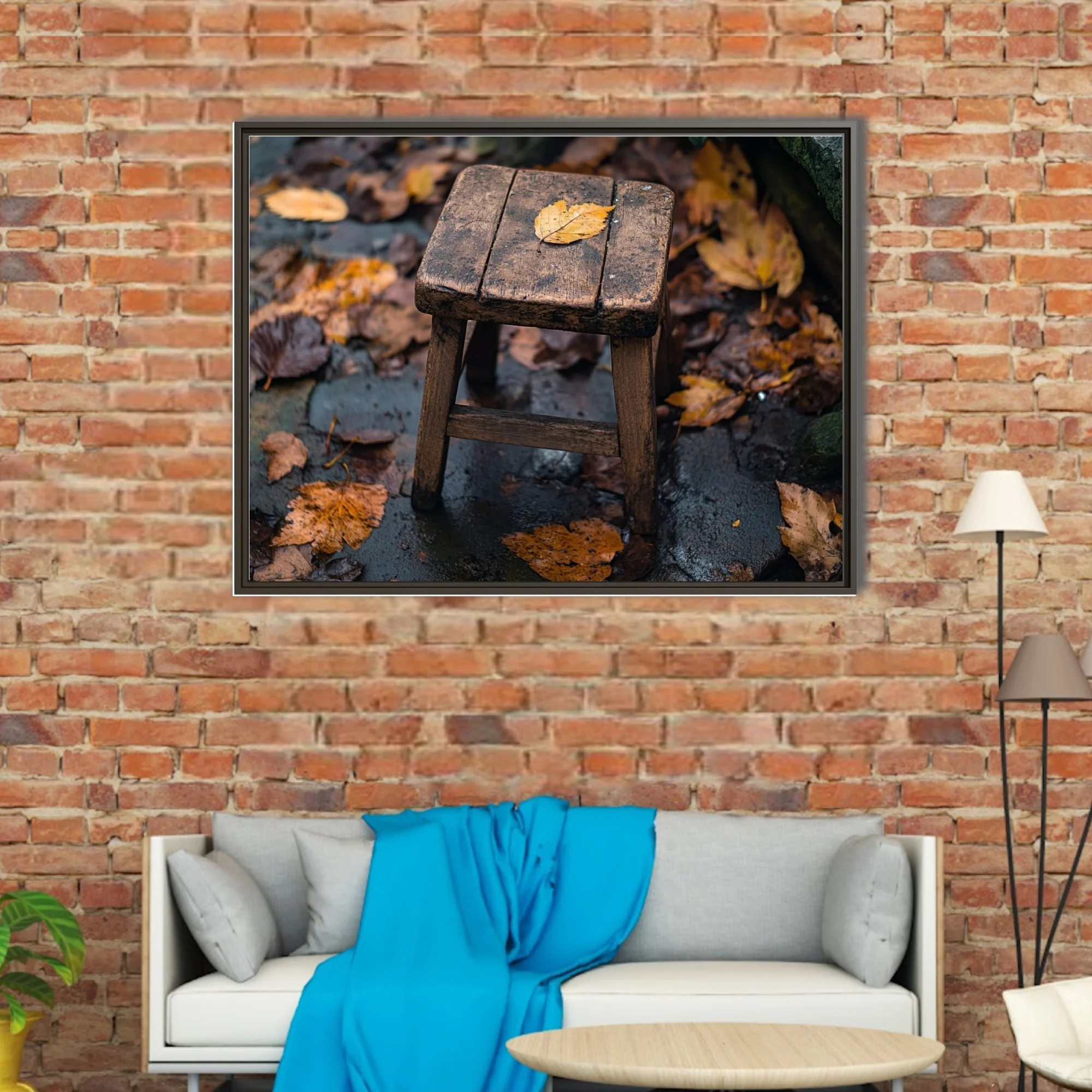 Rustic wooden stool with fallen autumn leaf on rain-wet stone surrounded by foliage