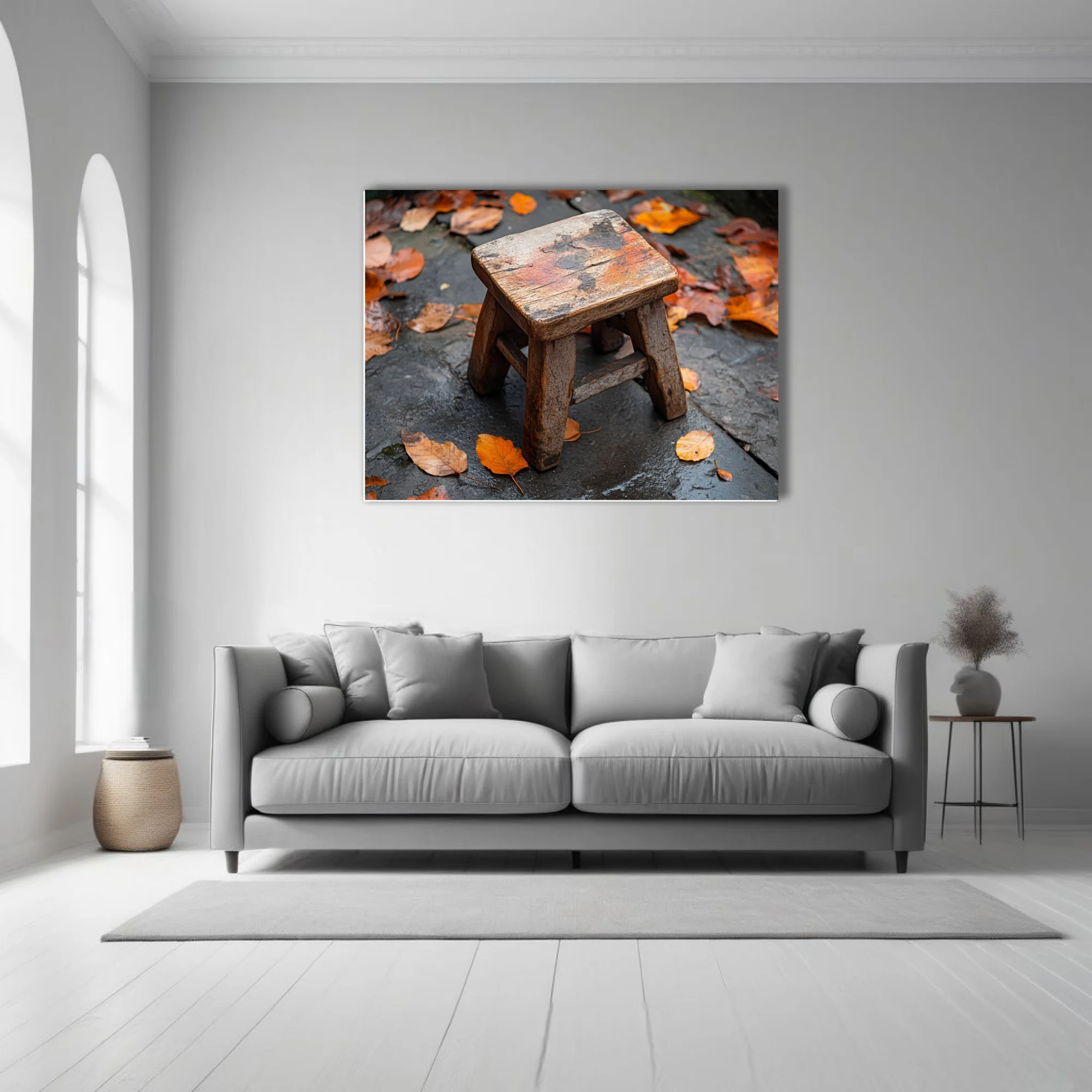 Rustic weathered wooden stool on wet stone surrounded by autumn leaves