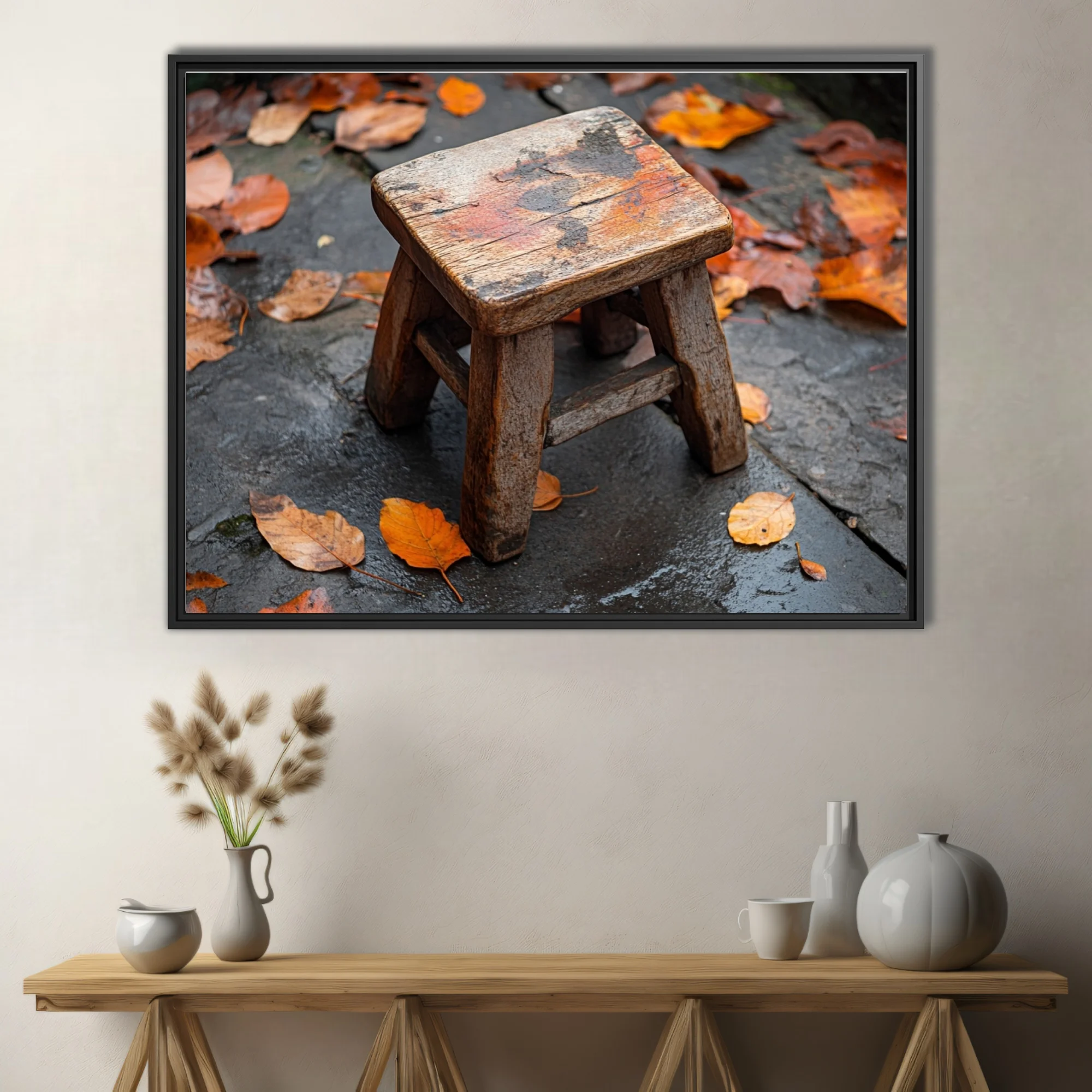 Rustic weathered wooden stool on wet stone surrounded by autumn leaves
