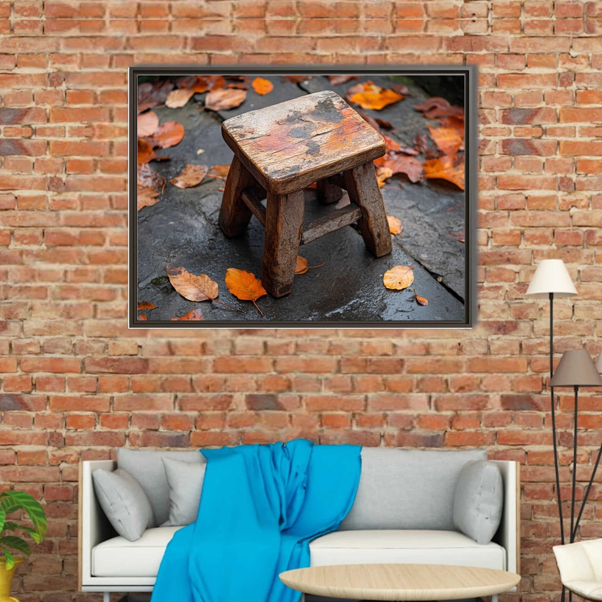 Rustic weathered wooden stool on wet stone surrounded by autumn leaves
