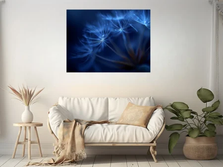 Macro blue dandelion seed heads glowing with ethereal light on deep cobalt background