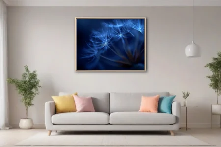 Macro blue dandelion seed heads glowing with ethereal light on deep cobalt background