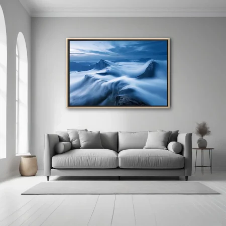 Long-exposure cloudscape flowing over mountain ridges in deep blue tones