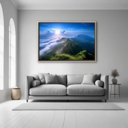 Mountain landscape above clouds, vivid blue sky and lush green ridgelines