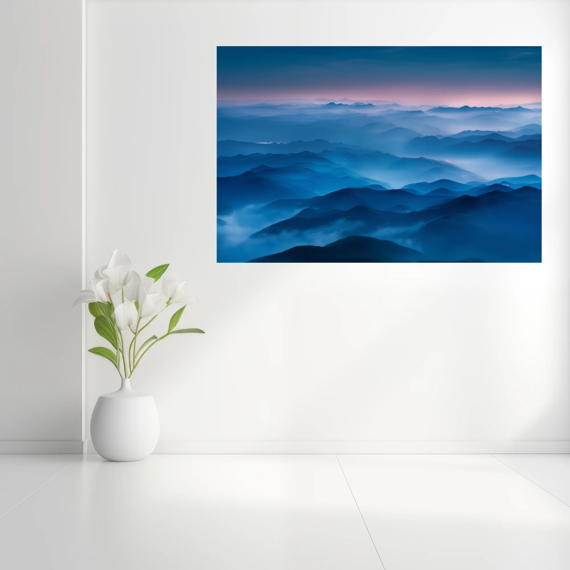 Misty blue mountain ranges at twilight, layered ridgelines fading into pink dusk sky