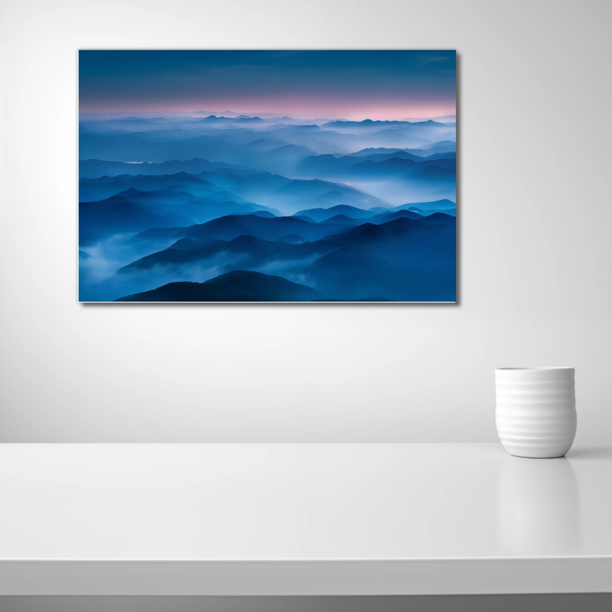 Misty blue mountain ranges at twilight, layered ridgelines fading into pink dusk sky