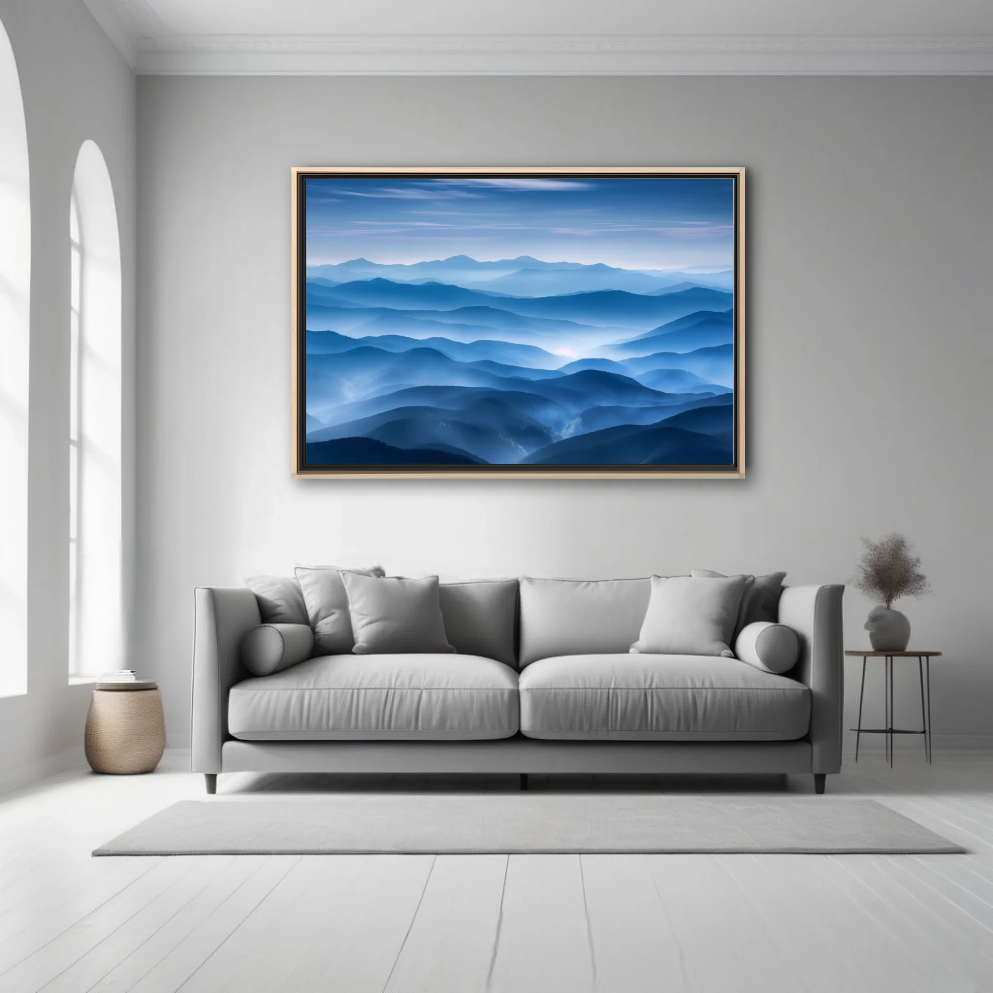 Misty layered mountain landscape in cool blue tones with atmospheric haze and soft glow