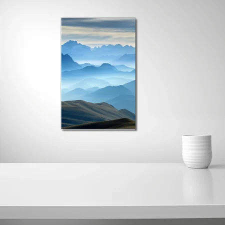 Layered mountain landscape in misty blue tones with hazy ridgelines