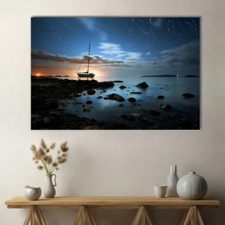 Long-exposure night seascape with sailboat silhouette, star trails, and glowing horizon