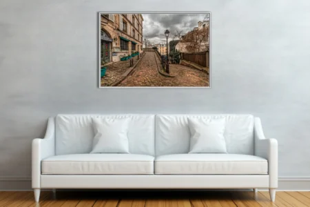 Moody Parisian cobblestone street with historic facades and overcast skies