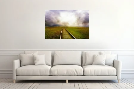 Cinematic railroad track curving through green fields toward dramatic glowing storm clouds