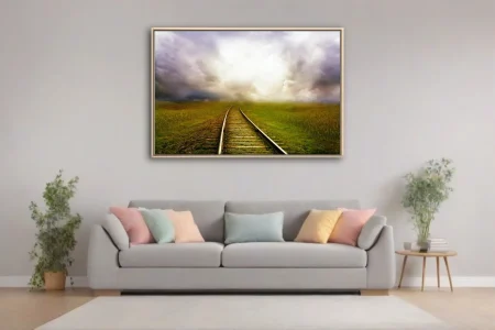 Cinematic railroad track curving through green fields toward dramatic glowing storm clouds