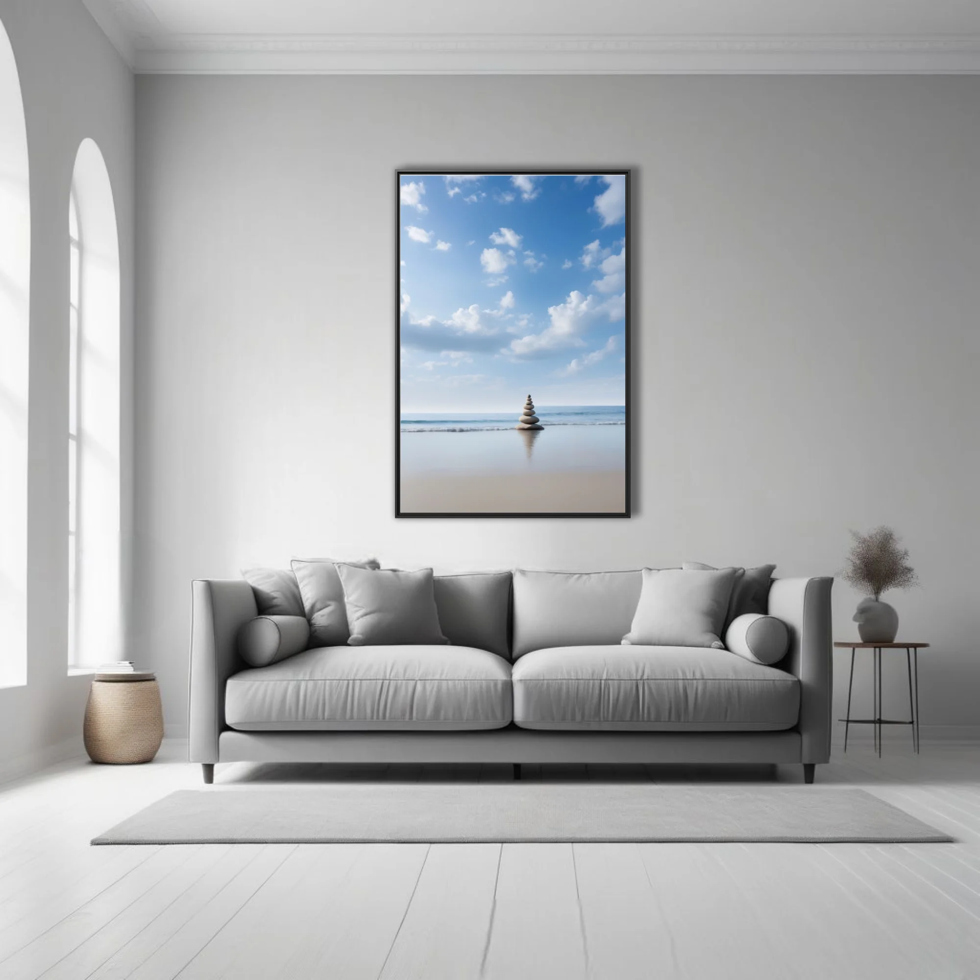 Minimalist zen stone cairn on calm beach, blue sky, soft coastal palette