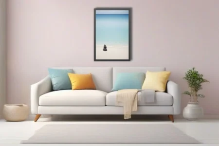 Minimalist zen stone cairn on white sand beach with calm turquoise ocean